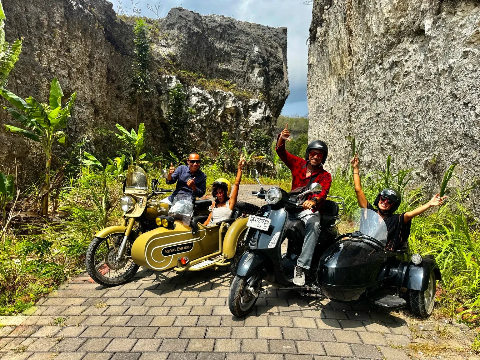 Guests and guides with fully visible sidecars in a stone village passage